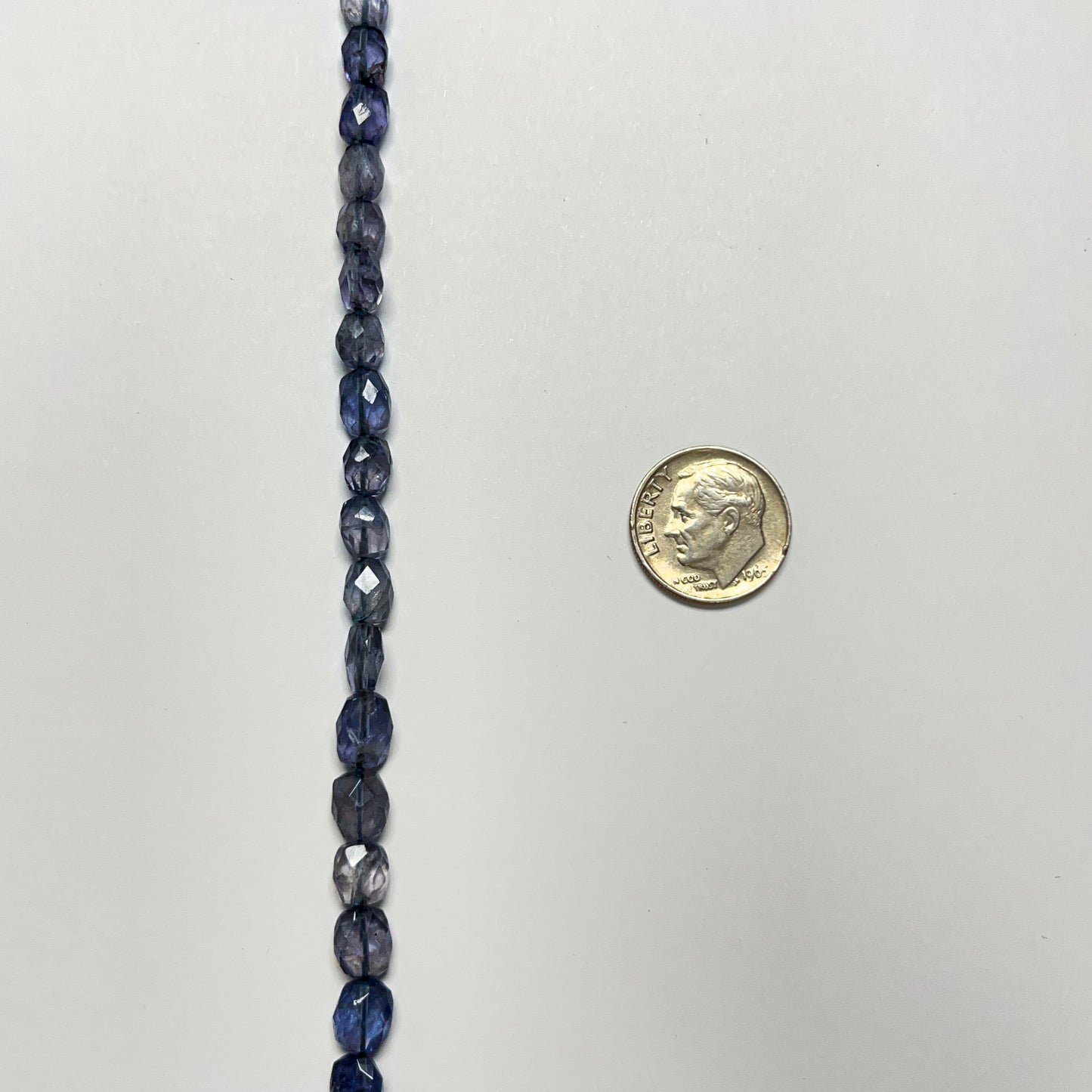 7–8mm x 5–6.5mm Faceted Oval Iolite 14.5 inch ~52 pcs/strand