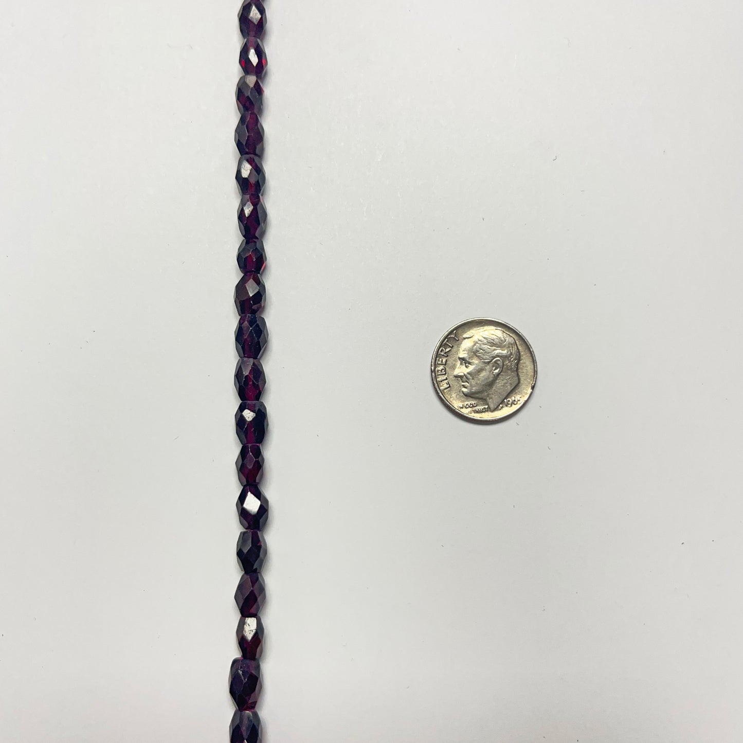 7–7.5mm x 5–5.5mm Faceted Oval Garnet 14 inch ~56 pcs/strand