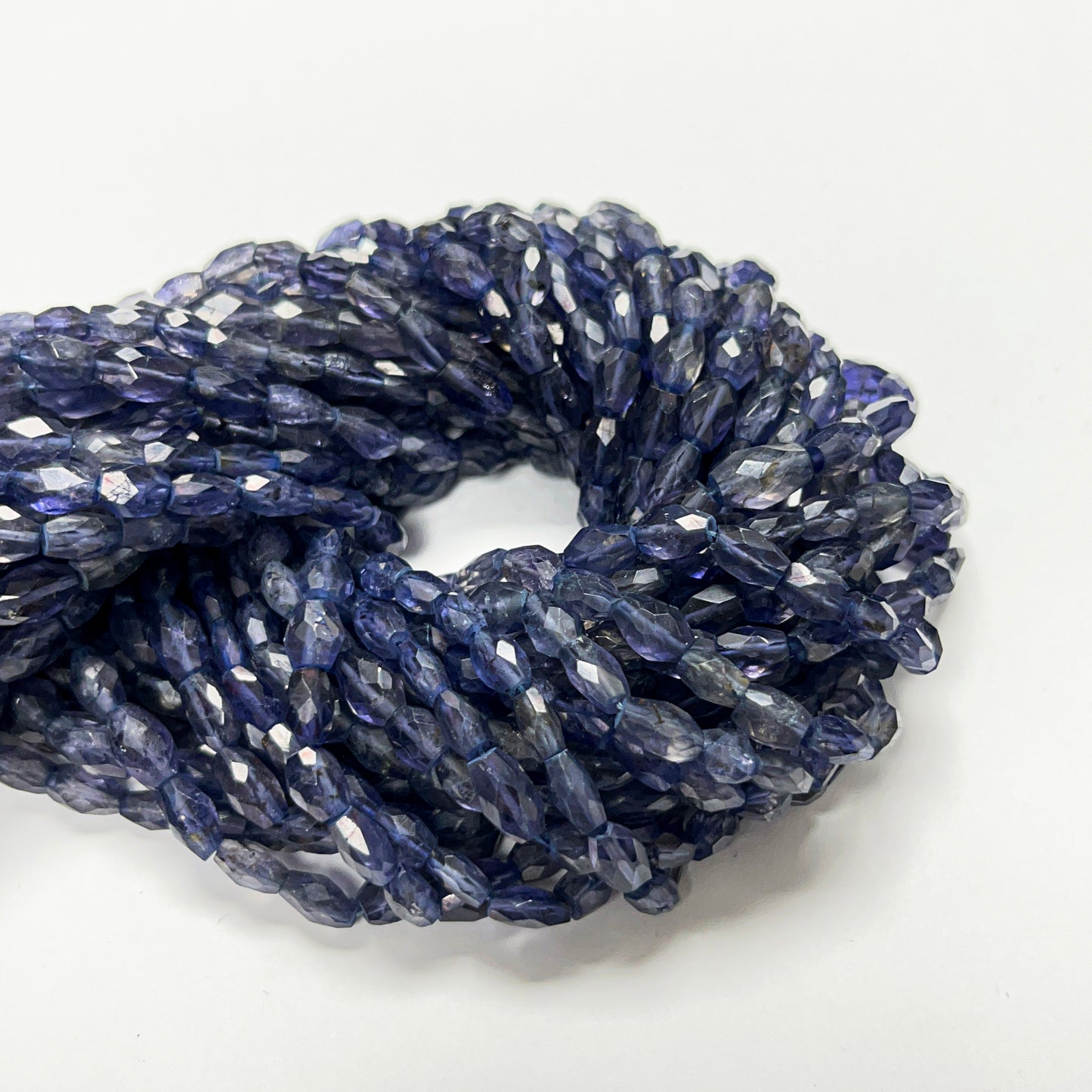 6–7mm x 5–6mm Faceted Oval Iolite 14.5 inch ~52 pcs/strand