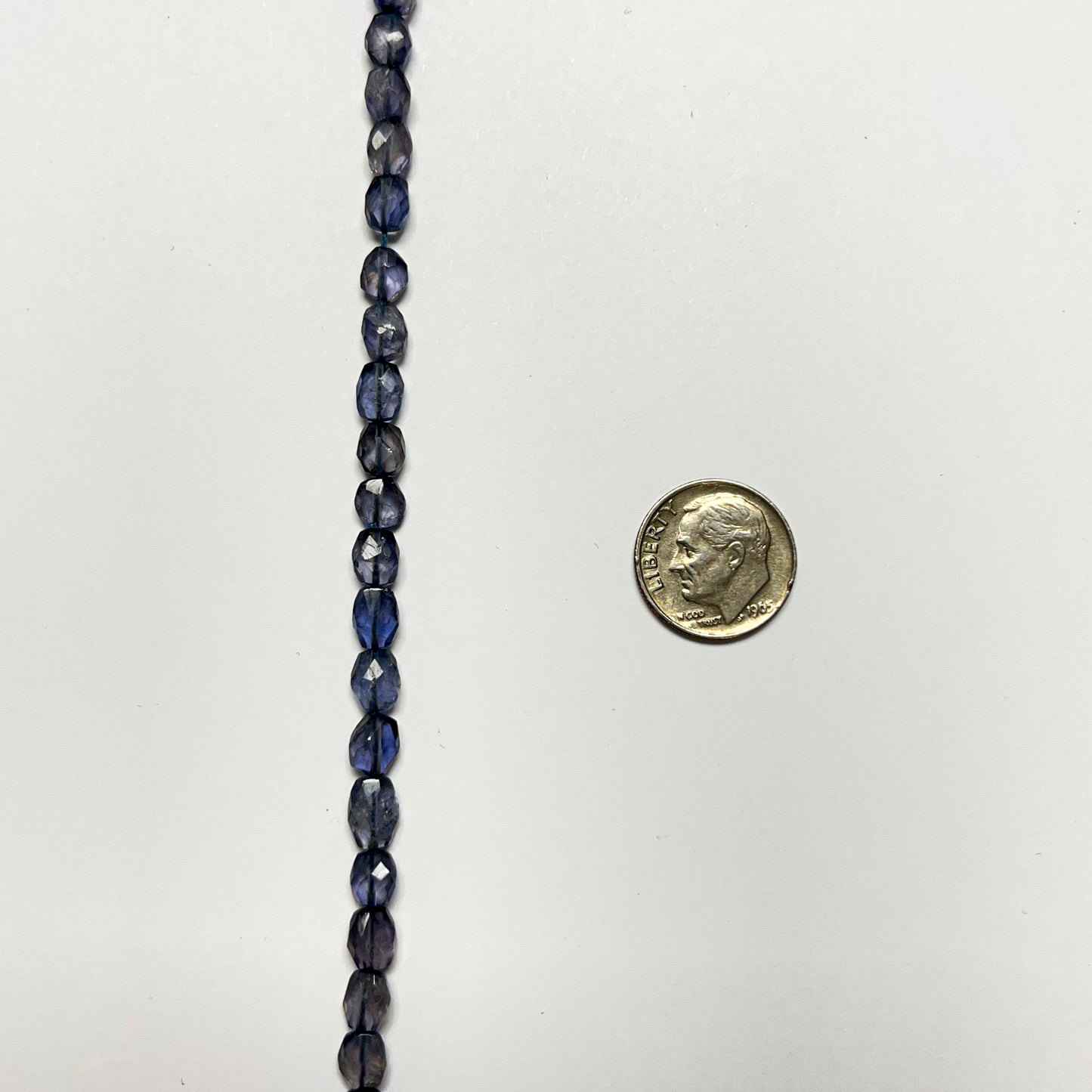6–7mm x 5–6mm Faceted Oval Iolite 14.5 inch ~52 pcs/strand