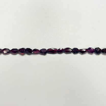 7–7.5mm x 5–5.5mm Faceted Oval Garnet 14 inch ~56 pcs/strand