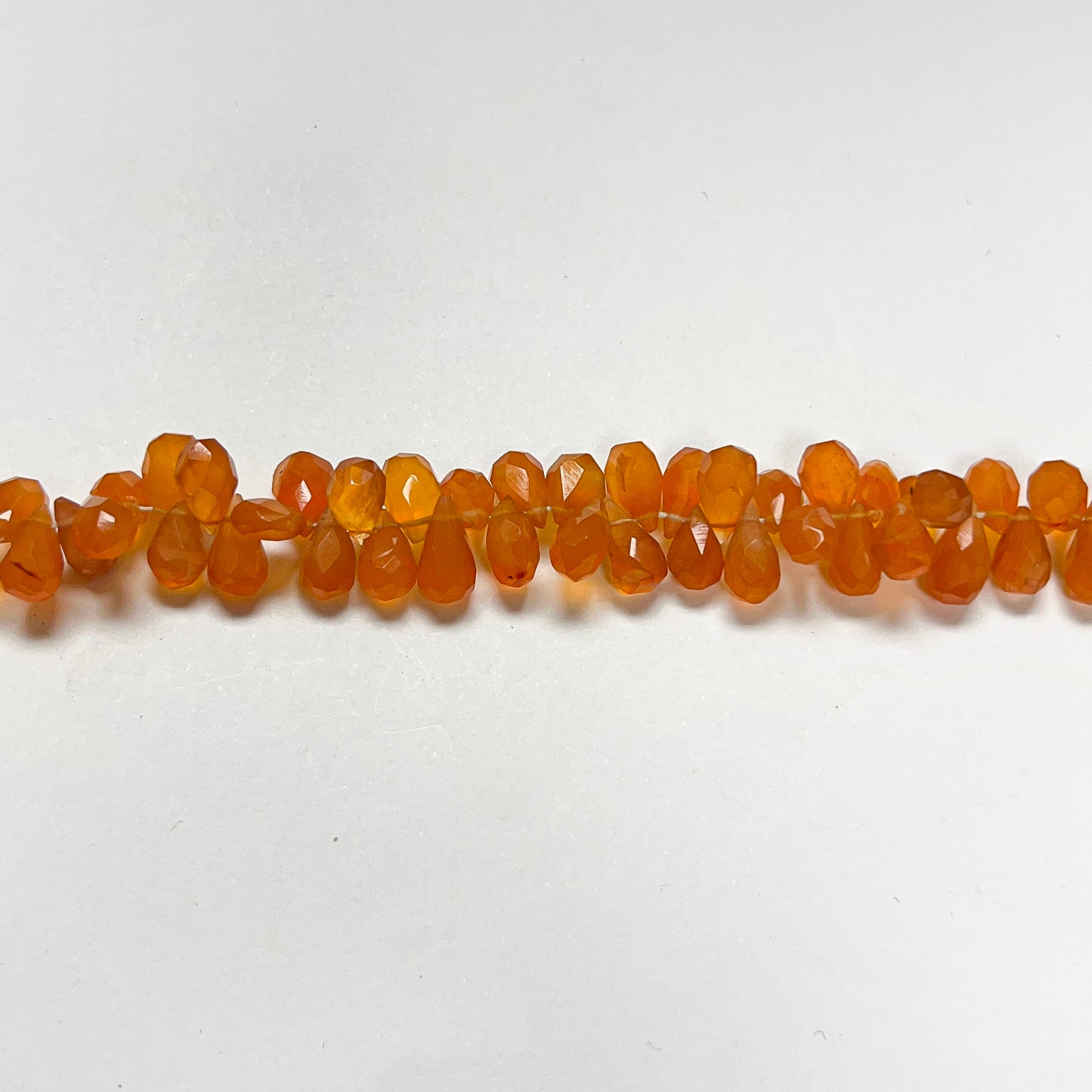 3.5–4.5mm x 7–8mm Faceted Carnelian Drops 16 inch ~165 pcs/strand